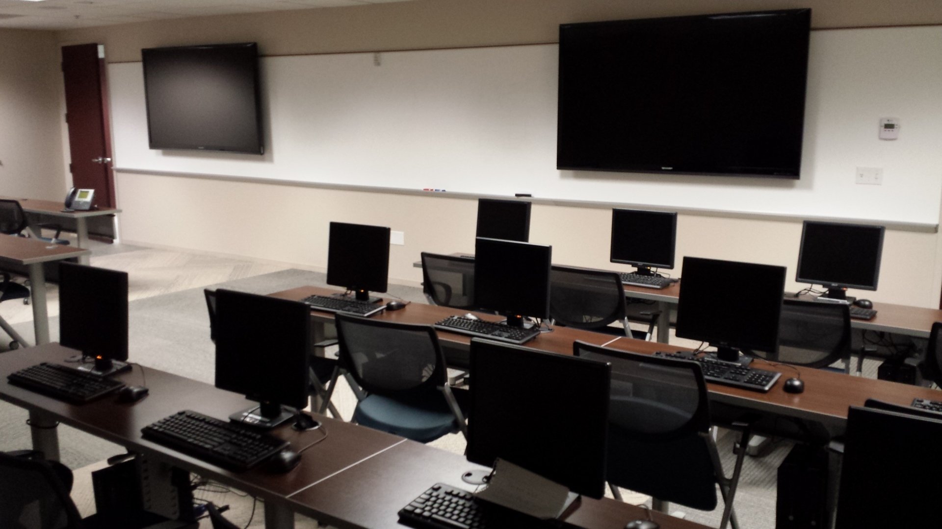 Commercial training room with multiple screens for corporate presentations